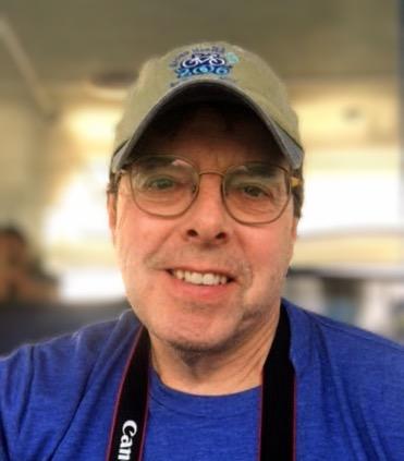 Board of Directors candidate Eric Jensen wearing a bike hat